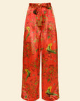 Red floral and bird patterned pants on a beige background