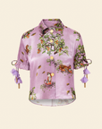 A purple blouse with floral print and embellishments, including beaded drawcord sleeves and a brass beaded collar.