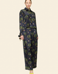 Model wearing a dark floral outfit on a plain background