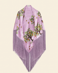 A purple scarf with a floral pattern and fringe detailing along the edges.