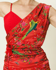 Red dress with floral and bird patterns on a plain background