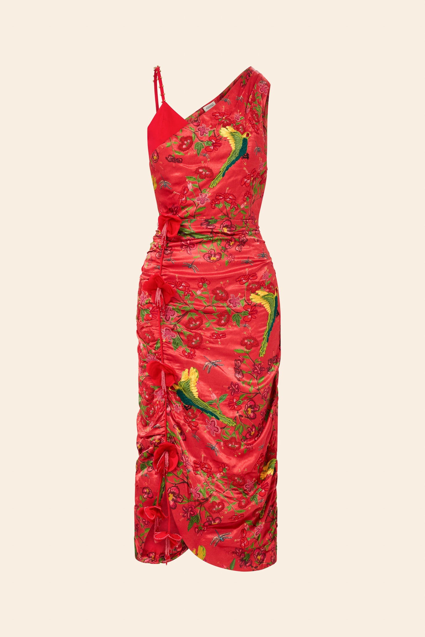 Red dress with green floral patterns on a beige background