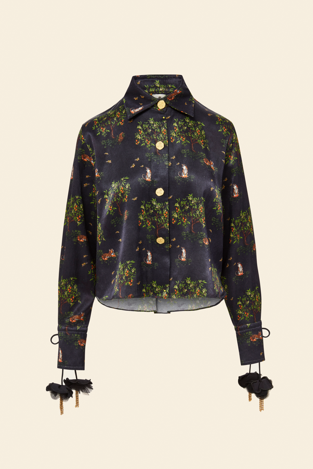 Long sleeve shirt with floral and animal patterns, featuring brass beads on the collar, a hidden placket, pleating, and drawcord at the cuffs.