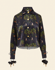 Long sleeve shirt with floral and animal patterns, featuring brass beads on the collar, a hidden placket, pleating, and drawcord at the cuffs.