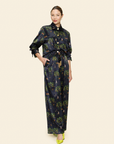 Woman wearing a floral patterned outfit on a plain background