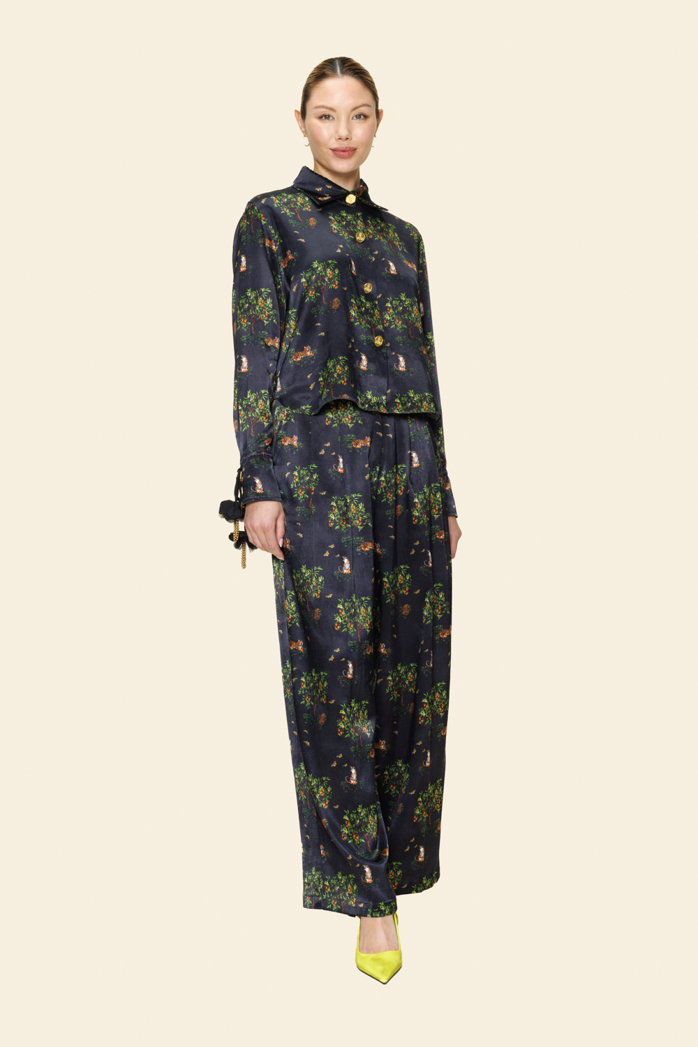 Model wearing a dark floral outfit on a plain background