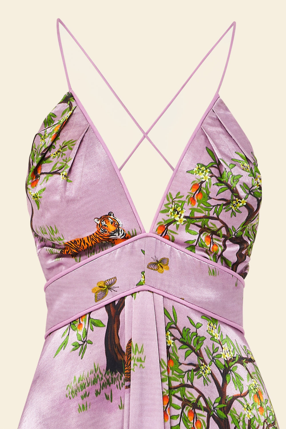 Purple dress with nature-themed print on a beige background