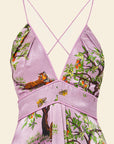 Purple dress with nature-themed print on a beige background
