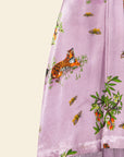 Purple fabric with tiger and butterfly print on a light yellow background