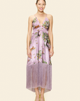 Woman wearing a floral dress on a plain background