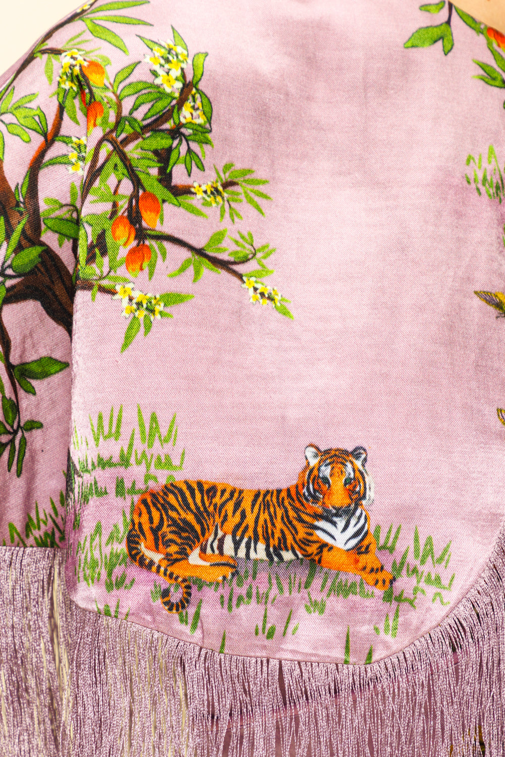 Pink fabric with a tiger and tree design, resembling a scarf.