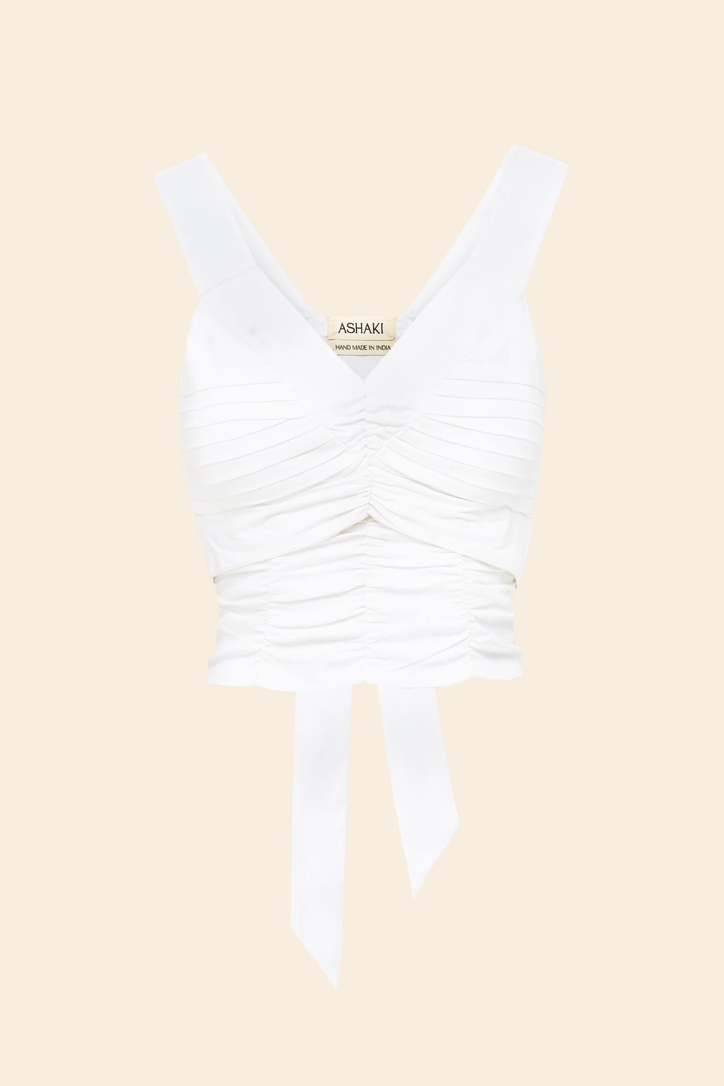 white rouched top on beige background