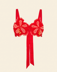 A red beaded hibiscus floral top with tulle ruffles and sequins, featuring adjustable straps and a bow detail at the back.