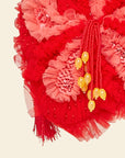 Red floral detail with yellow beads on a beige background