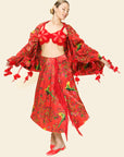 Woman wearing a red floral outfit on a beige background