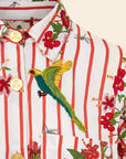 Close-up of a colorful shirt with floral and bird patterns on a white background