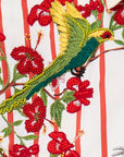 Embroidered design of a parrot and red flowers on a striped background