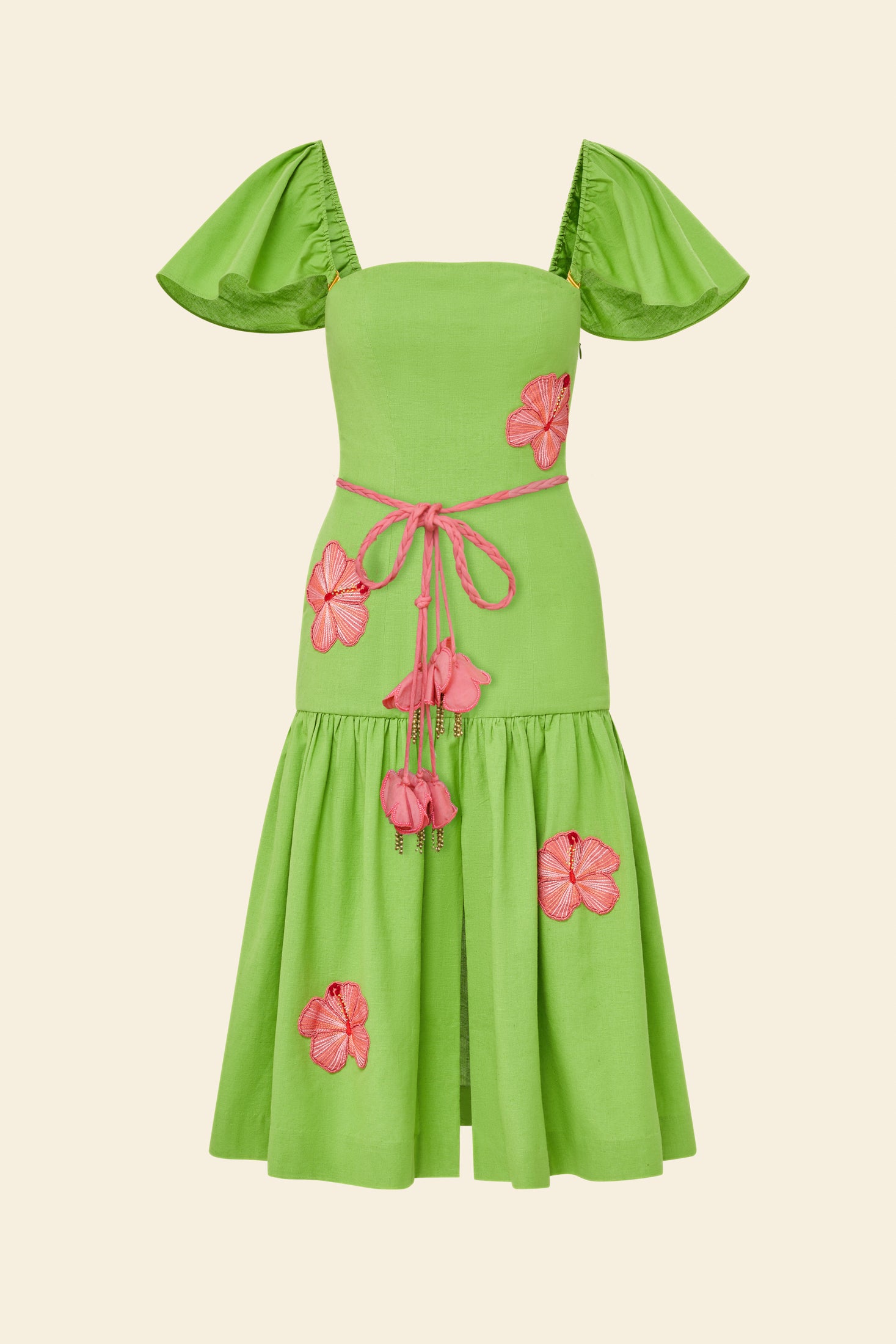 Green dress with pink floral accents on a beige background