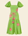 Green dress with pink floral accents on a beige background