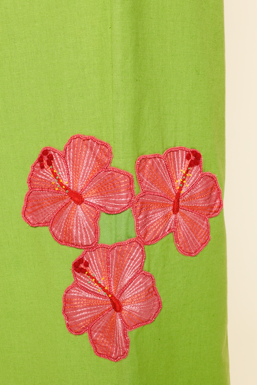 Red floral embellishments on a green and beige background