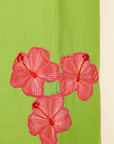 Red floral embellishments on a green and beige background