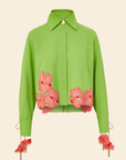 A long sleeve embroidered shirt in green with pink floral applique on the hem and cuffs, featuring drawcord cuffs.