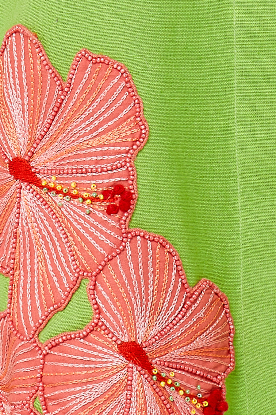 Embroidered pink hibiscus on green linen
