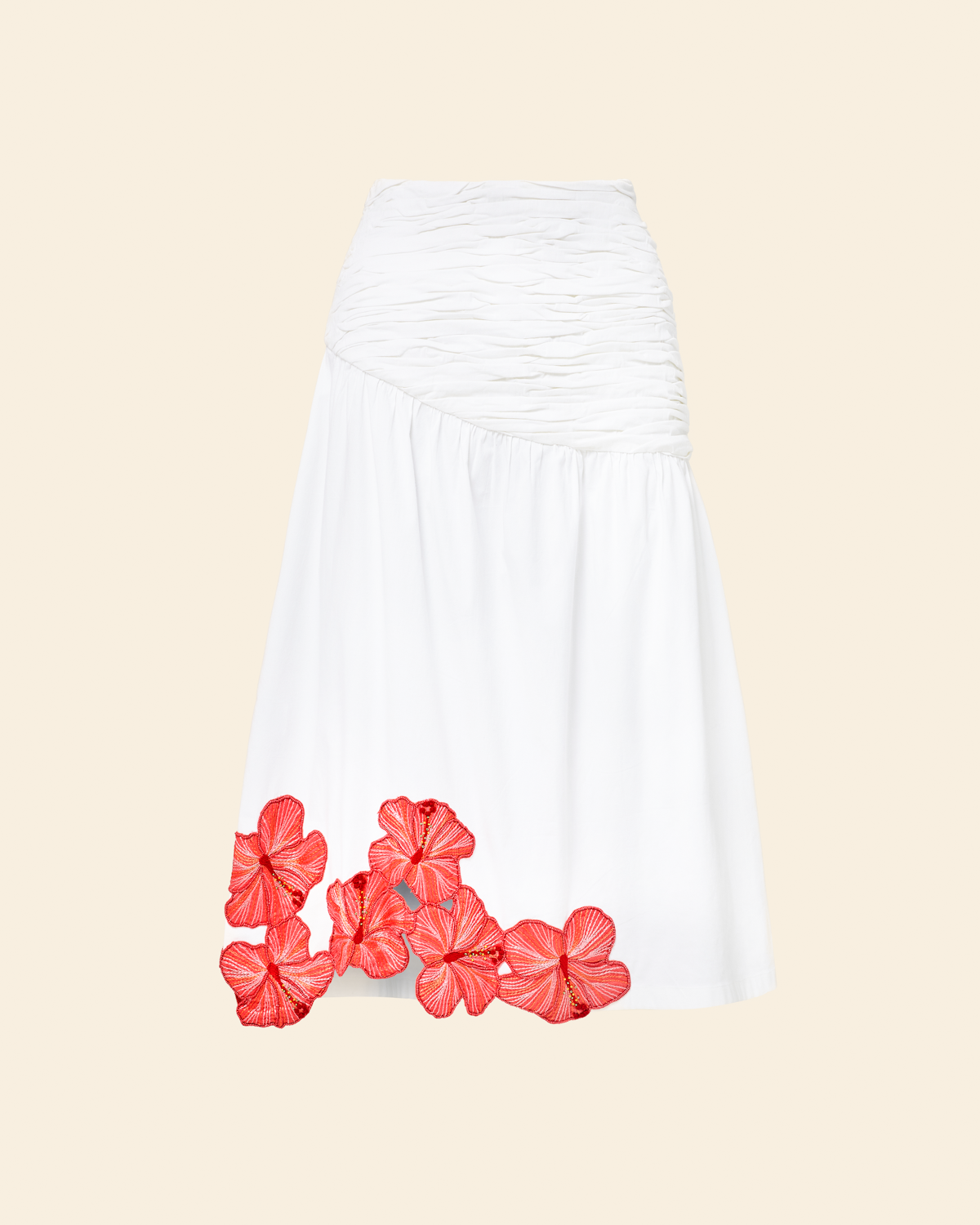 White skirt with coral floral accents on a beige background